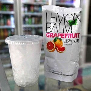 A picture of a pouch drink and cup of ice from a Korean convenience store.