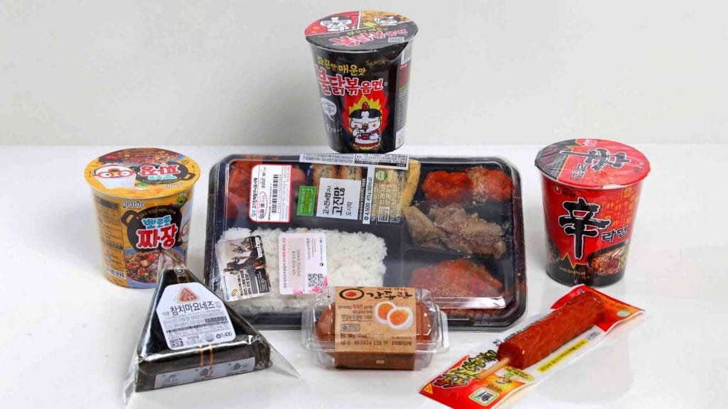 A picture of ramen, lunchbox, eggs, triangle gimbap, meat on a stick, and more food from a convenience store in Korea.
