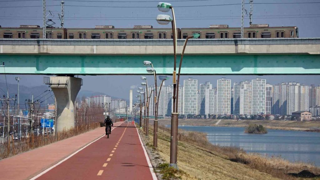 A picture of a Busan subway train crossing over the bike path in the city of Yangsan along the Cross-Country bike path.