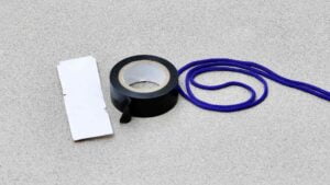 A picture of electric tape, cord, and velcro.