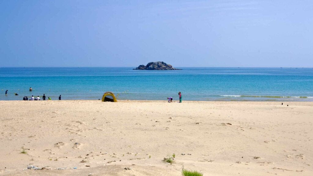 Sampo Beach features a tent on the sandy shore, with Geomeundo Island positioned in the East Sea.