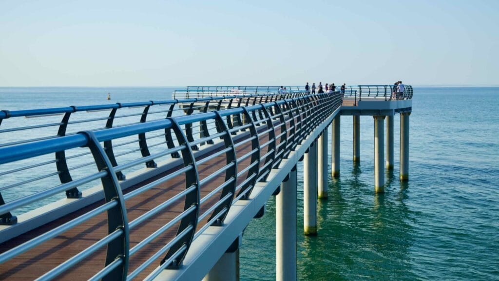 Visitors along the observation deck near Sun Cruise Resort in Jeongdongjin, overlooking the serene East Sea waters.