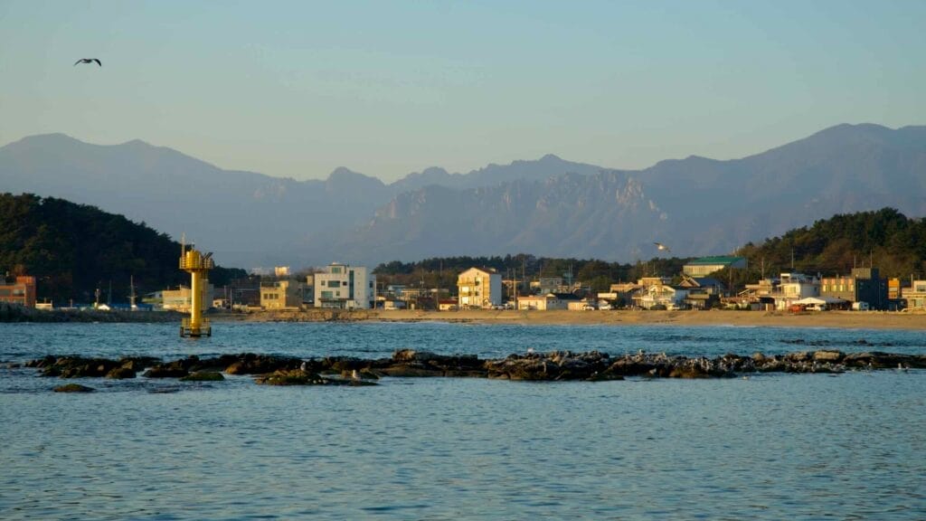 A view of Gyoam Beach and Gyoam Port with coastal buildings.