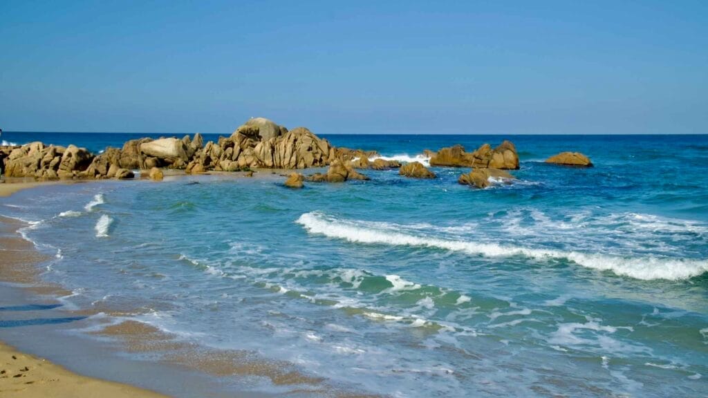 Gentle waves break against the rocks at Hajodae Beach, showcasing the serene beauty of the East Sea's clear waters and coastal charm.