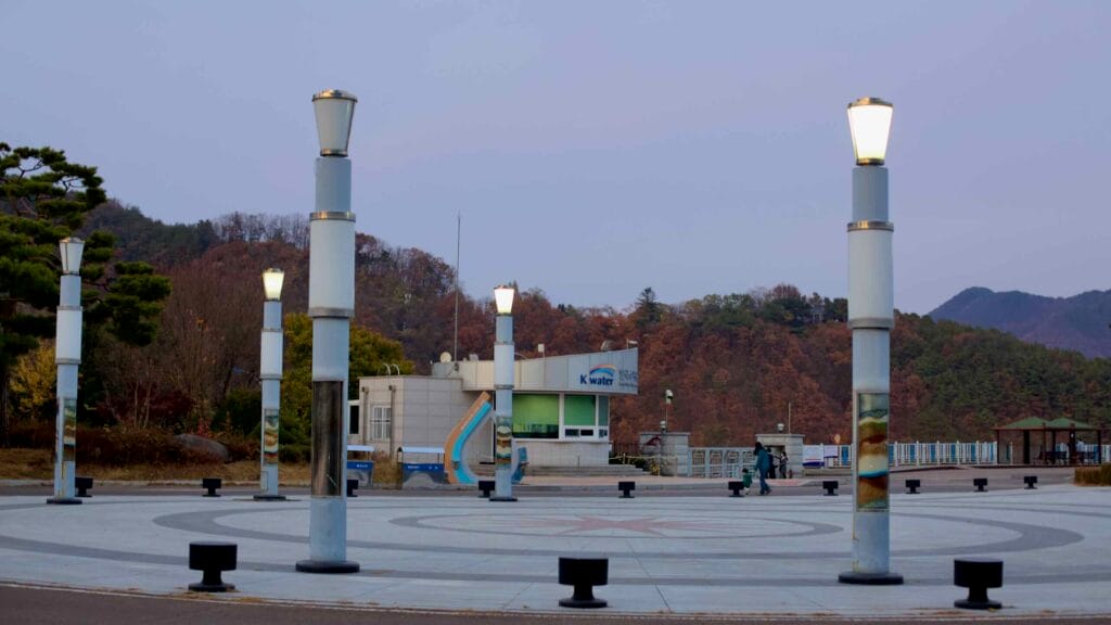 The courtyard of Daecheong Dam, a key hydroelectric facility spanning the Geum River, features modern lighting structures.