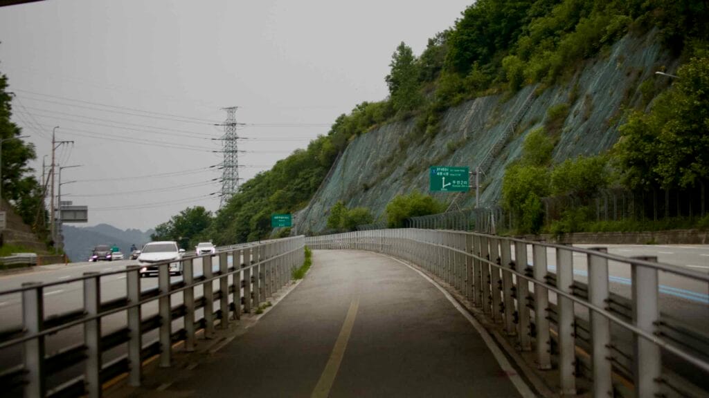 A cycling path runs parallel to North Star Road, bordered by guardrails.