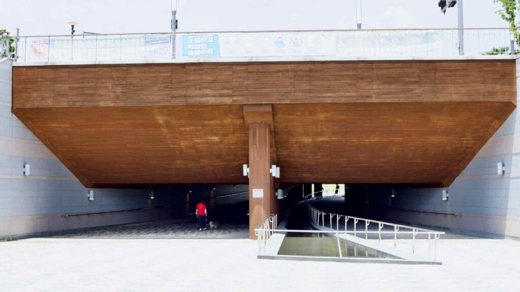 Sejong City, South Korea - May 26, 2021: A modern pedestrian underpass with wooden paneling and accessible walkways leading t…