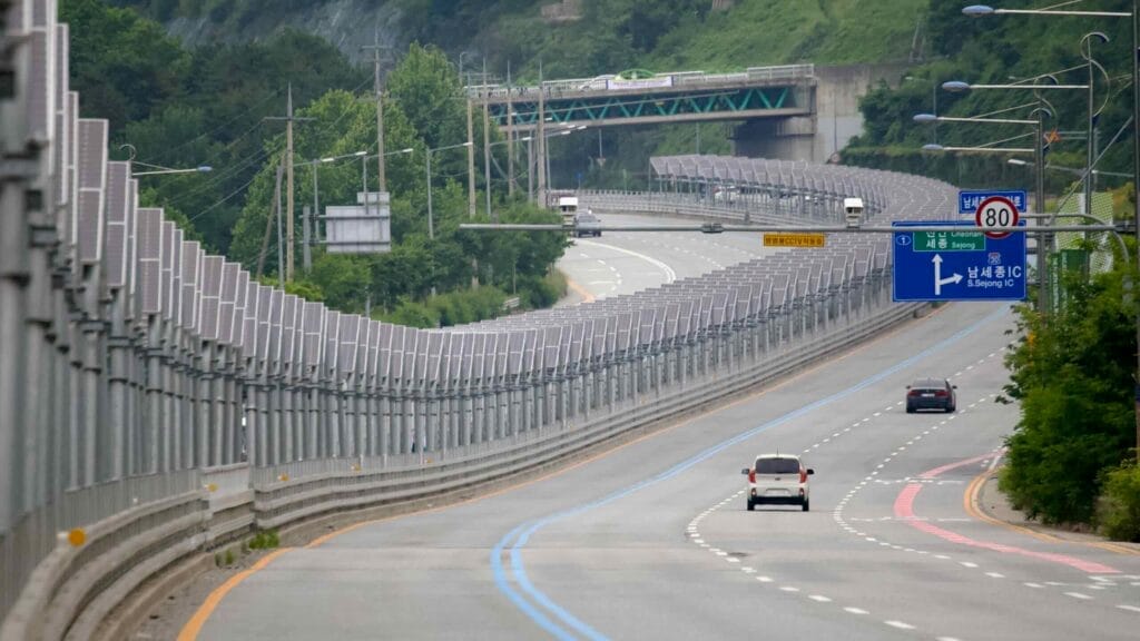 A highway with a parallel solar-covered bike path on North Star Road stretches toward Sejong City.