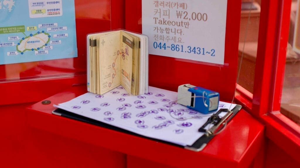 Inside Sejong-bo Certification Center, a cycling passport rests open next to a stamp pad.