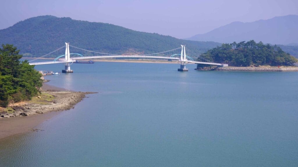 Haemaji Bridge spans the Seomjin River, connecting the mainland to a forested island. The modern suspension design enhances the scenic beauty of the coastal landscape.