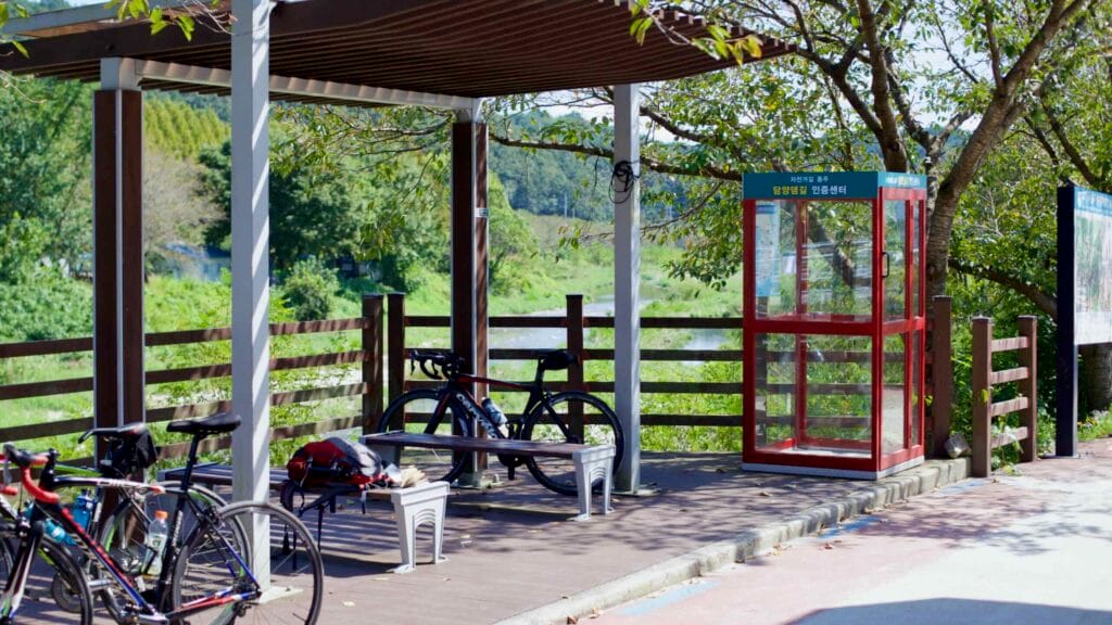 Cyclists rest at the Damyang Dam Certification Center along the Yeongsangang Bike Path.