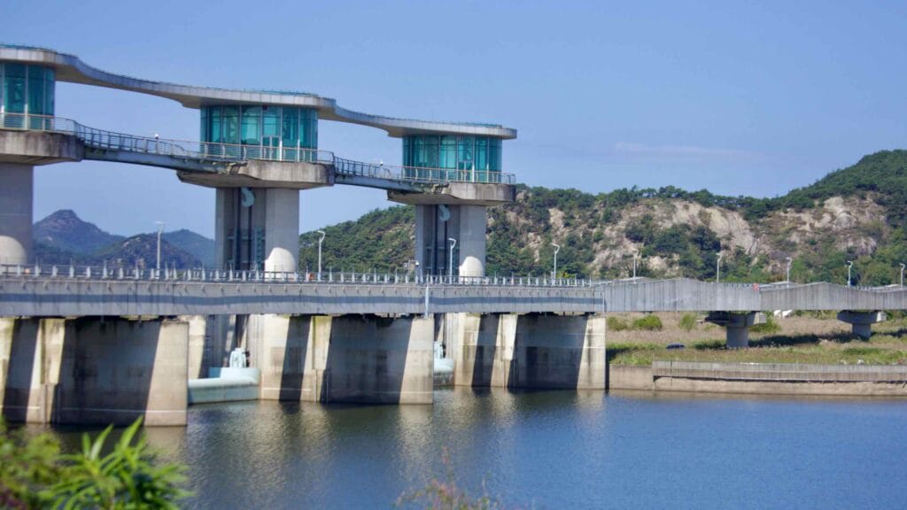 Juksan Weir stretches across the Yeongsan River, featuring observation decks and a bridge.