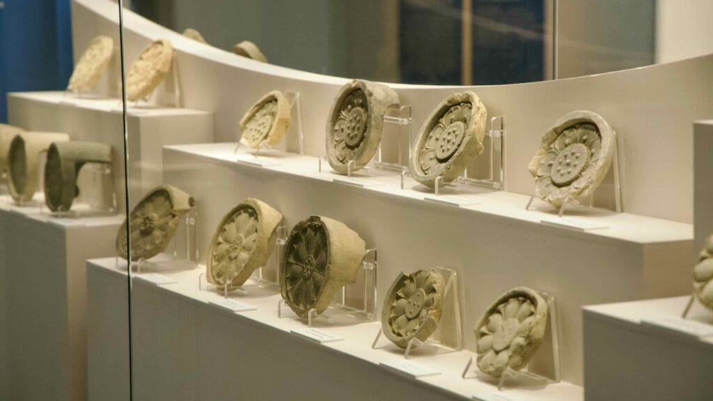 Curated row of floral-patterned roof tile ends at Buyeo National Museum.