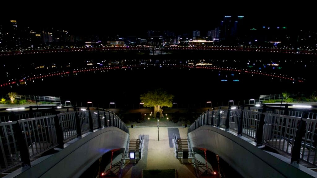 A nighttime view from the observatory on Geumgang Pedestrian Bridge reveals its circular descent.