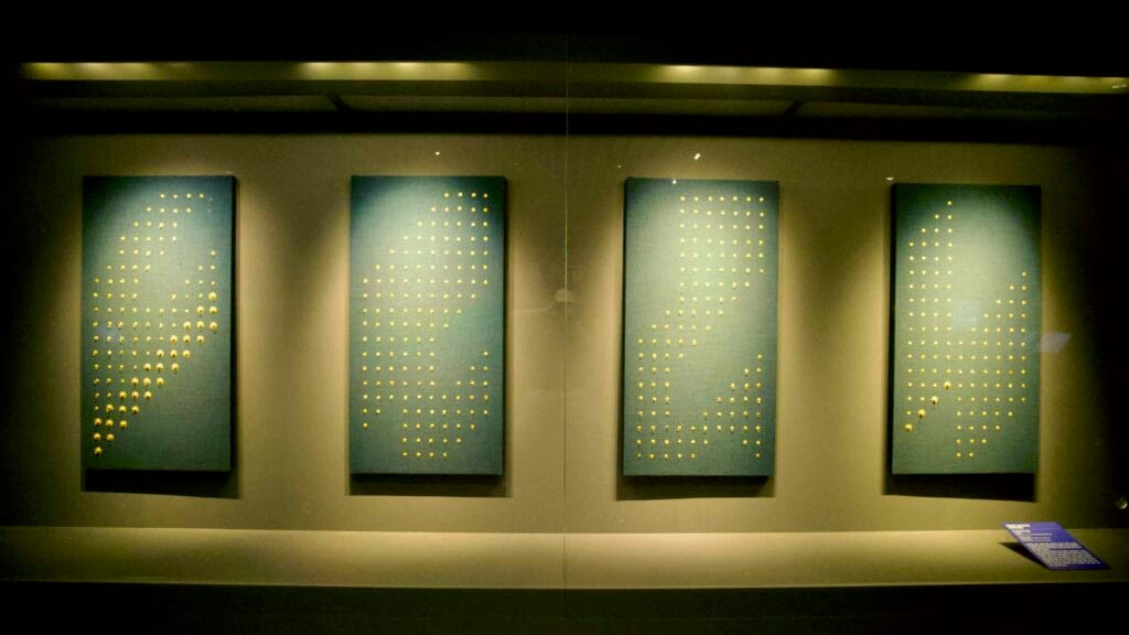 Hundreds of small gold ornaments from a Baekje royal burial displayed at Gongju National Museum.