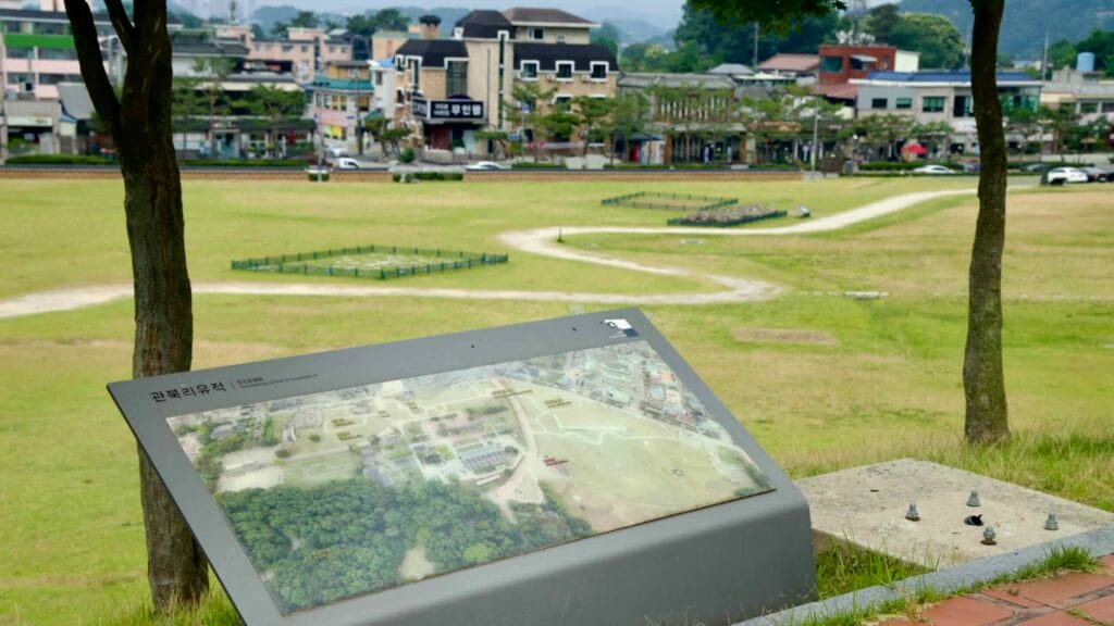 Gwanbuk-ri archaeological site sign, with views of palace ruins and the surrounding town.