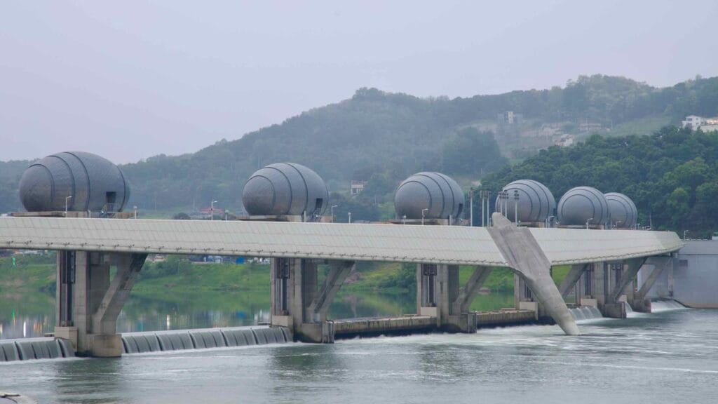 Seven distinctive egg-shaped gatehouses span Ipo Weir, blending industrial engineering with symbolic design over the South Han River’s flowing current.
