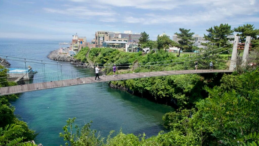 Yongyeon Cloud Bridge above the inlet toward the sea on Jeju’s north coast.