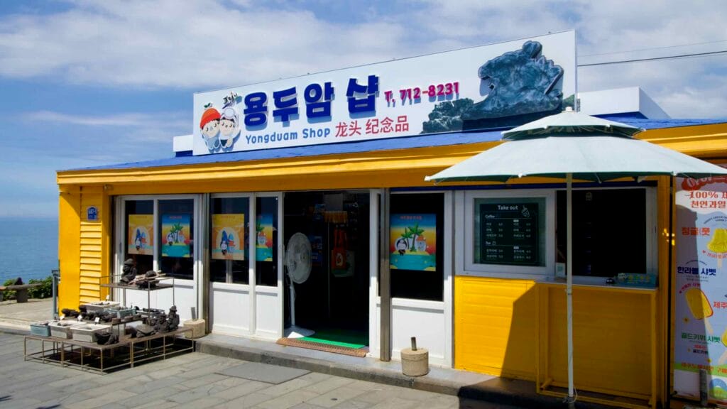 Bright yellow Yongduam Shop by the coast near Dragon Head Rock.
