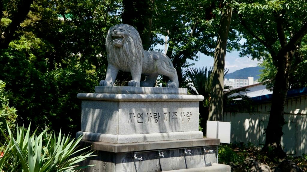 Granite lion statue on a public fountain near Yongduam.