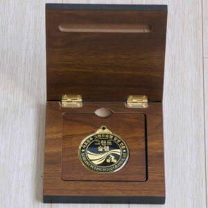 Grand Slam medal in its wooden display case.