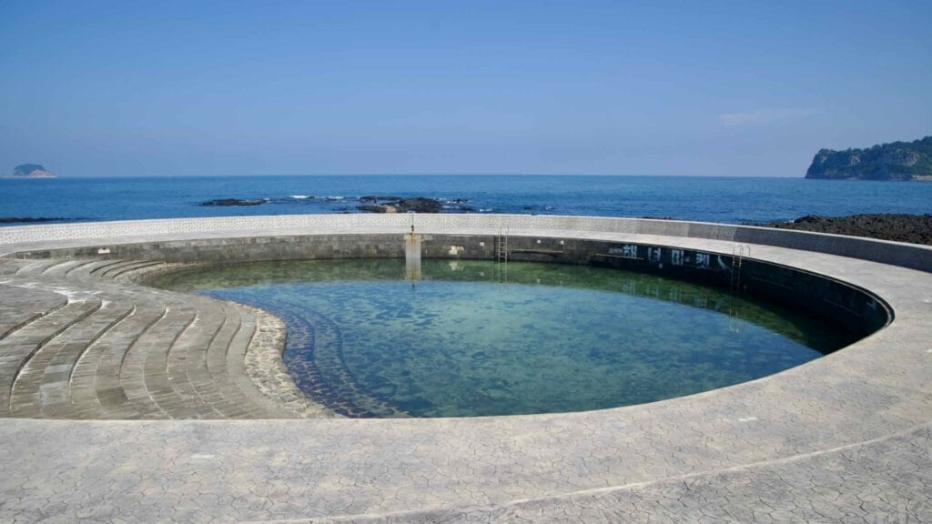 A circular seawater pool sits along the Beophwan shore.