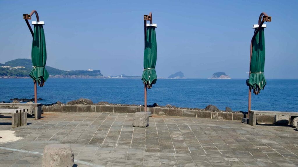 Folded umbrellas line a terrace facing the islands off Beophwan.