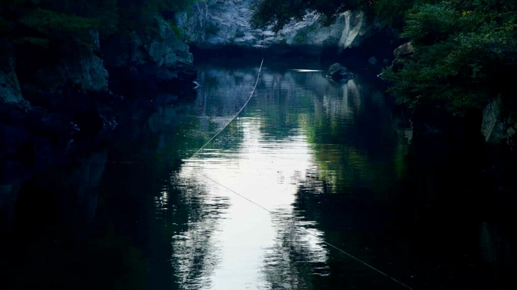 The narrow gorge at Soesokkak leads inland between forested rock walls.