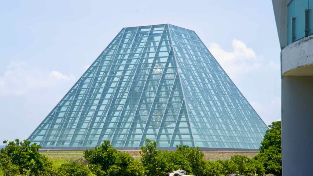 A faceted glass pyramid pavilion anchors the Phoenix Island resort at Seopjikoji.