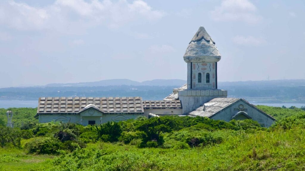 The former drama set All In House sits above Seopjikoji’s coast with a patterned tower and tiled roofs.