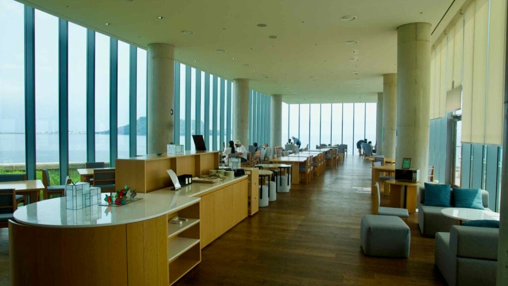 Inside the Phoenix Island Glass House café on the Sopjikoji Coast, long rows of wooden tables.