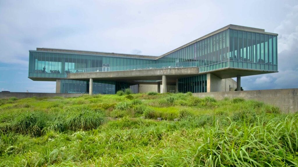 The Phoenix Island Glass House stretches above the shore at Sopjikoji, a low concrete structure wrapped in glass.