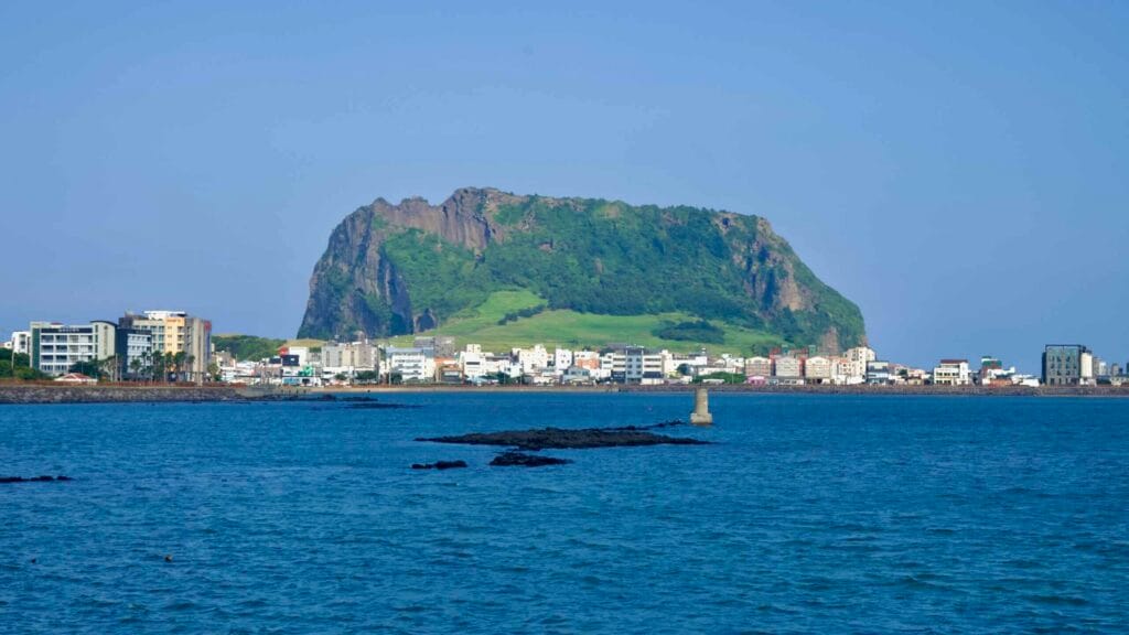 Seongsan Ilchulbong rises over the waterfront town of Seongsan-eup.