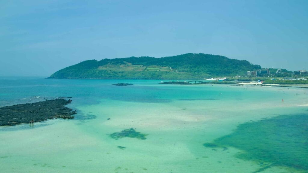 View shows Hamdeok’s blue lagoon, lava points, and Seoubong hill.