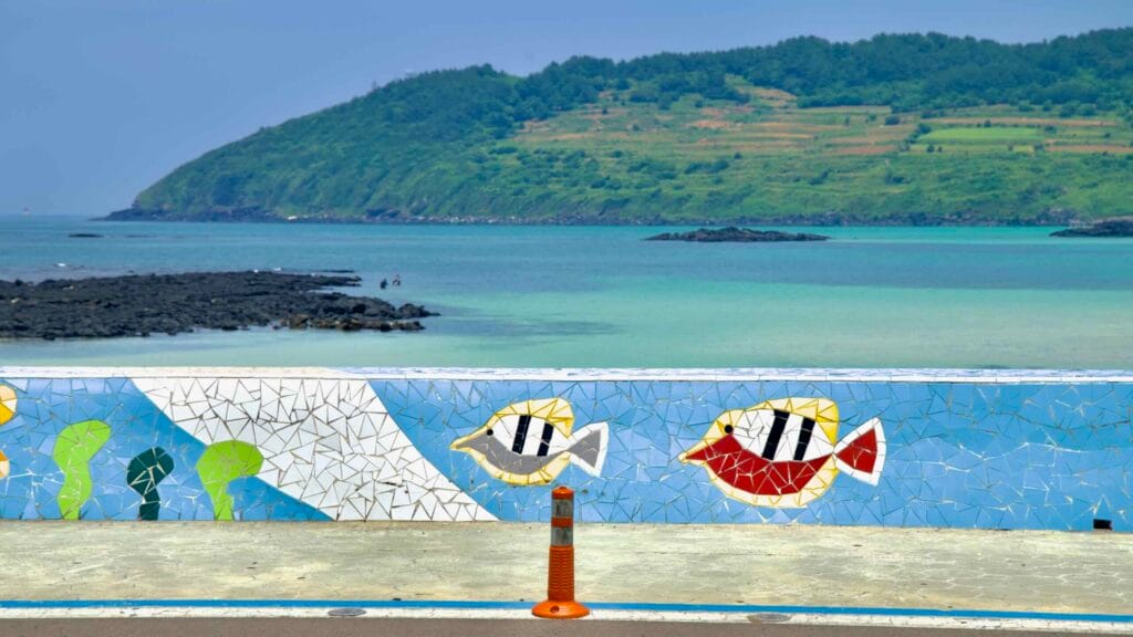 Colorful fish mosaics decorate the Hamdeok Seoubong Beach seawall.