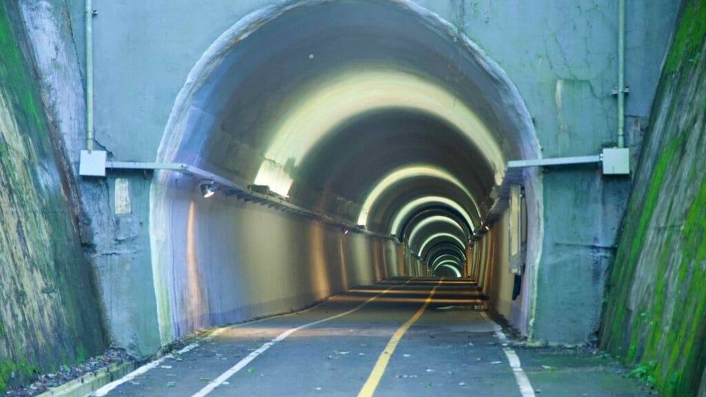 Concentric rings of light illuminate the mouth of Saekhyeon Tunnel, guiding the bike lane inside.