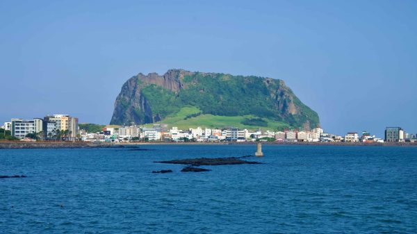 Seongsan Ilchulbong rises over the waterfront town of Seongsan-eup.