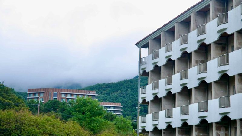 Resort balconies in Suanbo overlook misty hills and a distant hotel across the valley.