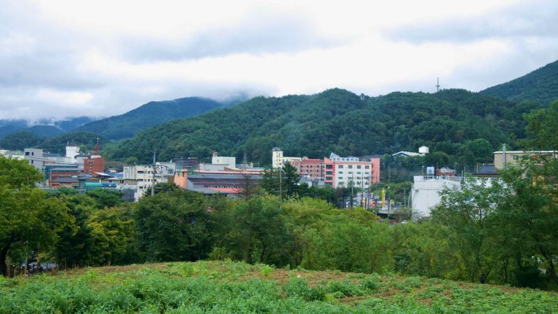 Suanbo’s hotels and bathhouses cluster in a narrow valley beneath cloud-wrapped hills.