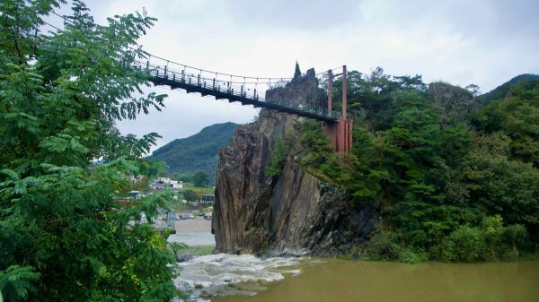 A high suspension bridge spans the Namhan River at Sujupal Peaks.