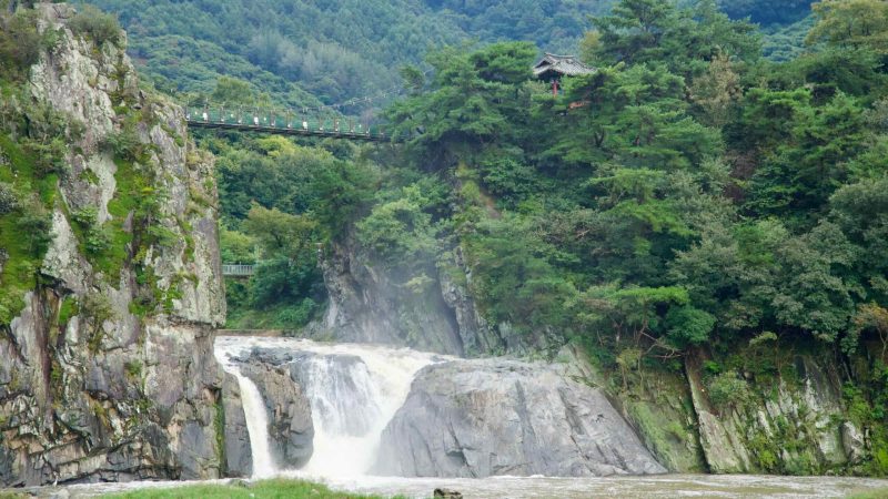 Across the river, the Cloud Bridge crosses between crags above Kal Rock Falls, with a traditional pavilion barely visible in the pines.