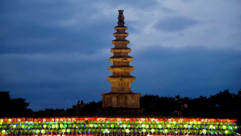 Chungju’s seven-story Central Tower rises above lanterns in Jungangtap Park as people gather.