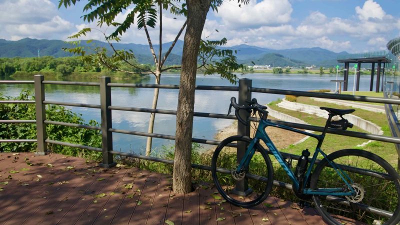 Play areas and grassy lawns dot the lakeside park in Chuncheon beside the broad reservoir.