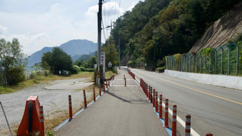 Orange posts form a narrow chicane on Baksa Road’s river bikeway in Chuncheon.