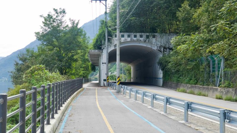 Dedicated bike lane bypasses the road at a tunnel portal along the Bukhangang.