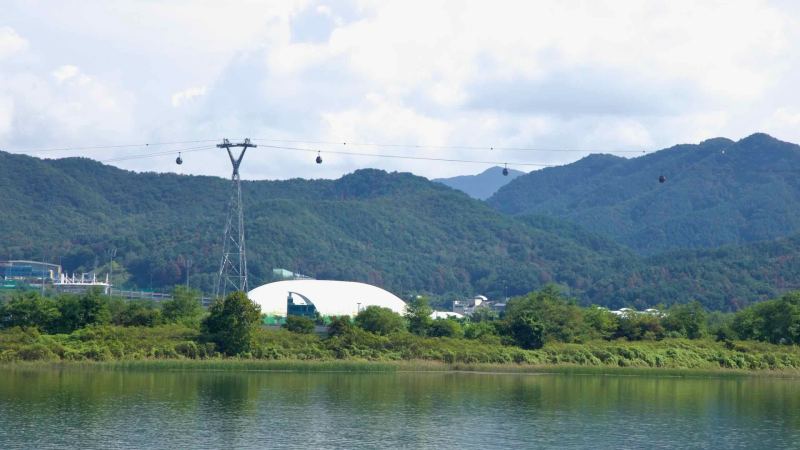 Gondolas on Chuncheon’s Samaksan Lake Cable Car cross the river near Songam Sports Town.