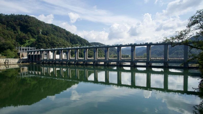 Uiam Dam spans the North Han River with long pillars mirrored on calm water.