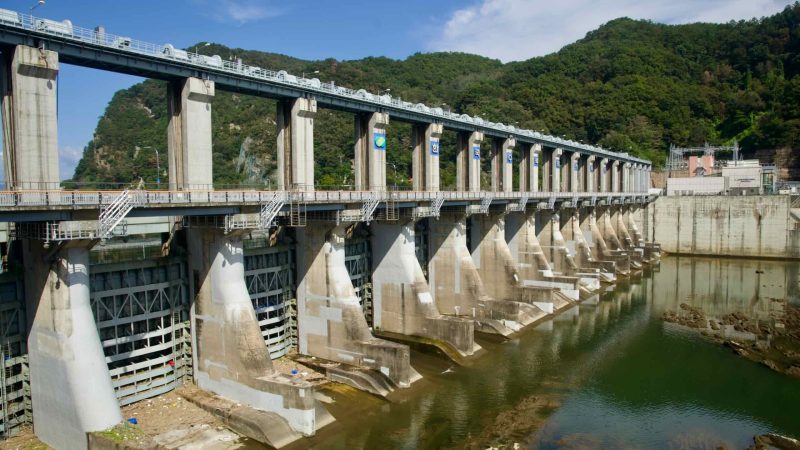 Downstream buttresses and sluice gates dominate the face of Uiam Dam.