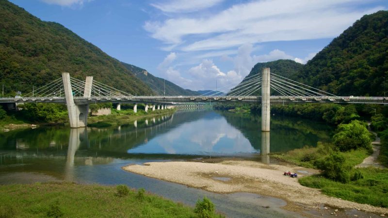 Gangchon Grand Bridge crosses the calm Bukhangang between low forested hills.