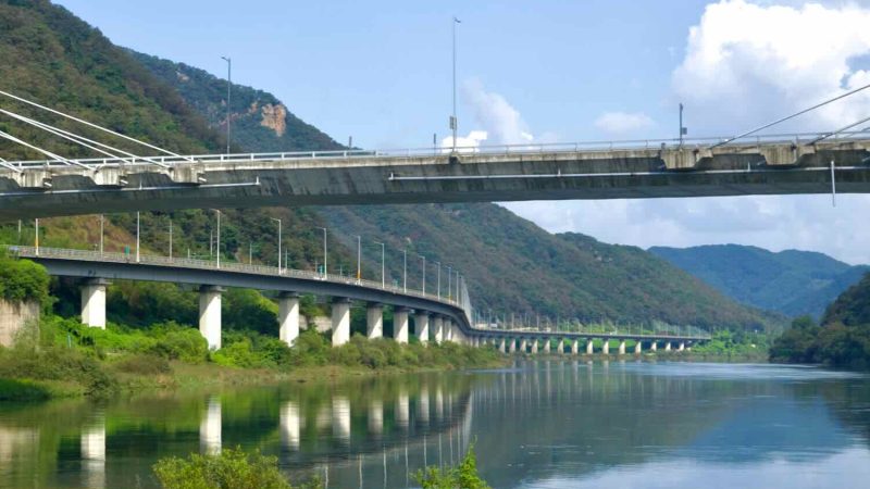 A close view shows the cable-stayed pylons of Gangchon Grand Bridge above the Bukhangang and its long downstream viaduct.
